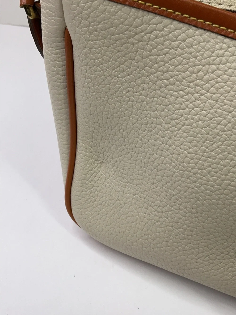 Dooney & Bourke cream and tan pebbled leather saddle bag